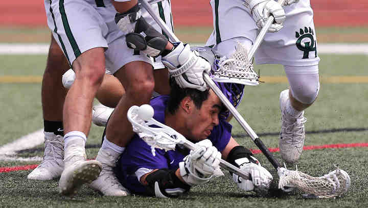 Tommy Clayton (11) of DeSales gets his helmet ripped off in the 3rd period during the Division II state lacrosse final against Ottawa Hills at Selby Stadium in Delaware. DeSales won 13-5.  (Jonathan Quilter / The Columbus Dispatch)